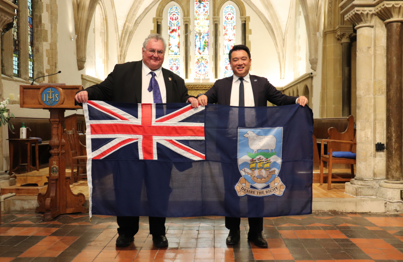 Local MP Alan Mak receives a Falklands Flag from Legislative Assembly Member for Stanley Roger Spink.